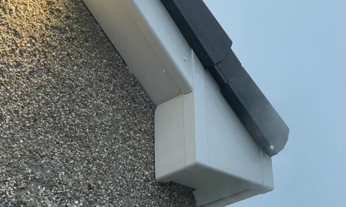 A gutter that is attached to the side of a building.